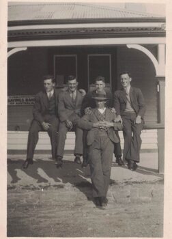 Five men outside a building.