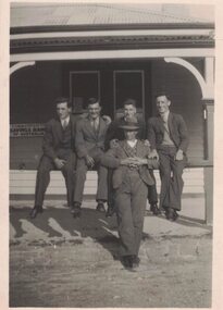 Five men outside a building.