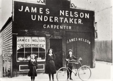 Three children in front of a building.