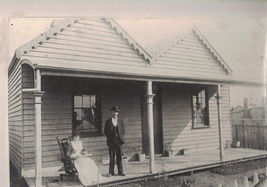 Couple on verandah of a house.