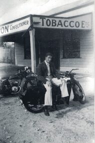 Man sitting on a motorcycle.