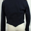 Long sleeve, waist length, navy blue wool jacket. Pointed shaped at bottom. Epaulets on shoulders.