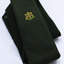 Bottle green tie with yellow and red star symbot printed on it. Folded, white background