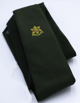 Bottle green tie with yellow and red star symbot printed on it. Folded, white background