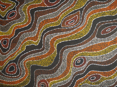 Aboriginal dot painting of orange, yellow, black and brown waves running diagonally across the canvas from bottom left corner to top right corner. Some circular patterns between the lines. White dots define the pattern and add texture on top.