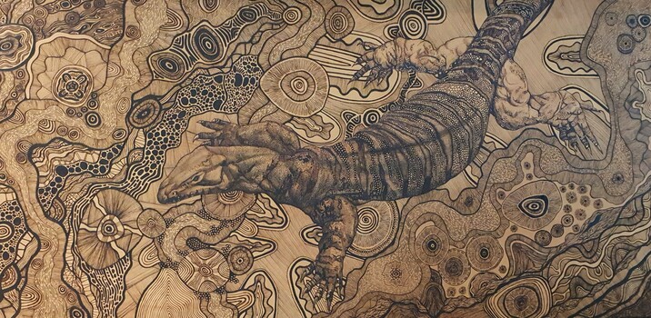 Image of large Goanna and other cultural markings and fine linework created through the technique of woodburning (pyrography) on a large MDF panel. 