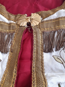 Ceremonial object - Benediction  cope, Cream damask satin benediction cope  with red lining. Multicoloured  and gold embroidery along rim  and IHS embroidered  on the the hood  which on this cope is  a mere ornamental appendage