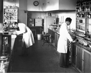 Workers in white coats in a laboratory at CSIRO Highett