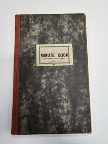 Hardcover book with marbled appearance and red cotton spine binding.