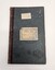 Green hard cover book with two white labels adhered to the front