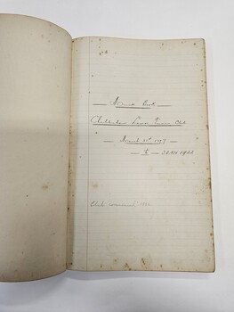 Green hard cover book with two white labels adhered to the front
