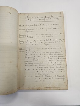 Green hard cover book with two white labels adhered to the front