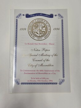 White paper document with red and gold printed text and an ornate border, featuring a diamond, around the edge of the page.