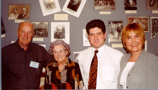 Four people lined up in front of a photo board