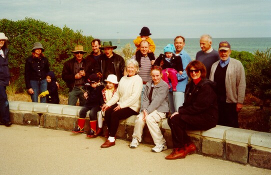 A group of sevent people gather together as part of a community tree plant activity