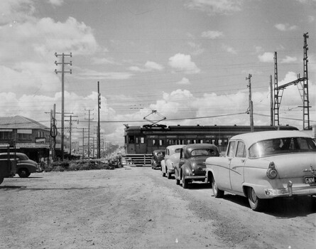 Cars lined up along South Road Moorabbin, waiting for the train to go through and the level crossing gates to be opened