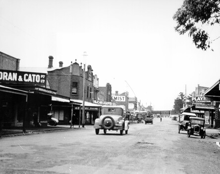 Cars travelling down Charman Road, Cheltenham, toward the train station.