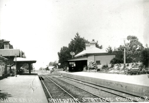 Station houses sit on each of the two platforms, separated by two sets of tracks.