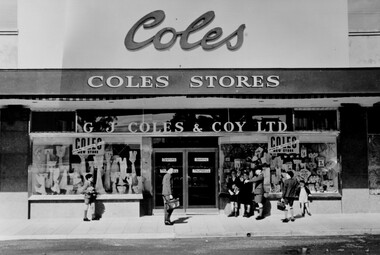 A group of boys standing around the entrance to the as yet unopened Coles store in Moorabbin