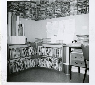 A photograph showing low shelves with picture books and part of a desk