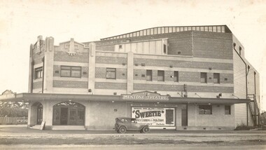 Large two storey building with a sign reading New Mentone Theatre