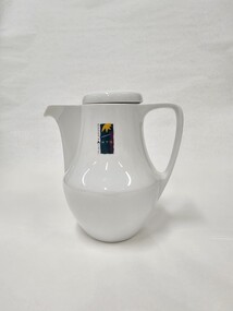 Small white coffee pot with purple, green and yellow Moorabbin Arts Centre Logo