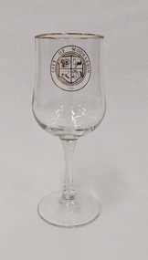 Red wine glass with gold edge and City of Moorabbin logo printed in gold