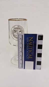 Wine glass with gold edge and City of Moorabbin logo including Nautical Archaeology scale to 8cm placed against right side