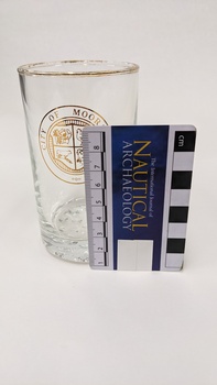 Water glass with gold edge and City of Moorabbin logo including Nautical Archaeology scale to 8cm placed against right side