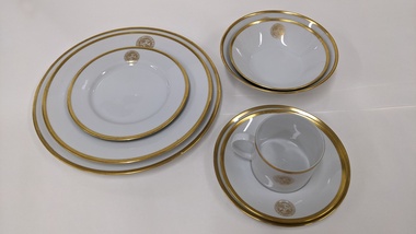 A seven-piece, gold edged place setting with City of Moorabbin logo