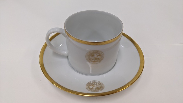 White cup and saucer with gold edging and City of Moorabbin logo