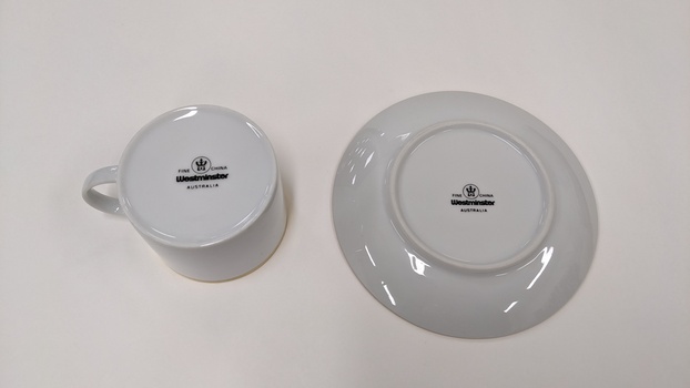 Base of white cup and saucer, separated