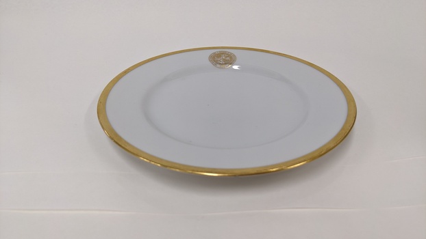 White bread and butter plate with gold edging and City of Moorabbin logo 