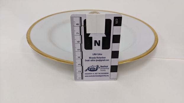 White entree plate with gold edging and City of Moorabbin logo with scale to 8cm placed against centre