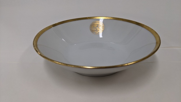 White soup bowl with gold edging and City of Moorabbin logo 
