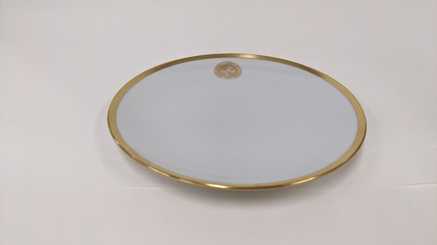 White underplate with gold edging and City of Moorabbin logo 