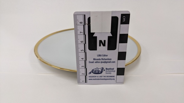 White underplate with gold edging and City of Moorabbin logo with scale to 8cm placed against right-hand side
