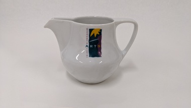Small white milk jug with purple, green and yellow Moorabbin Arts Centre Logo