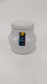 Small white sugar bowl with purple, green and yellow Moorabbin Arts Centre Logo