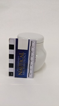 Small white teapot with purple, green and yellow Moorabbin Arts Centre Logo with small scale to 8cm placed against left side