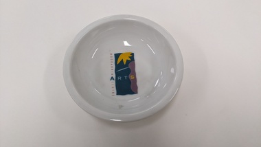 Small white finger bowl with purple, green and yellow Moorabbin Arts Centre Logo