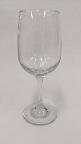 Red wine glass with white Kingston Arts logo printed on it