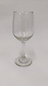 White wine glass with white Kingston Arts logo on front