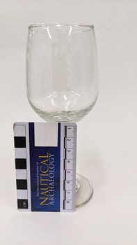 White wine glass with Kingston Arts logo in white printed on front, with scale to 8cm against left-hand side of glass