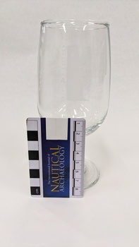 Beer glass with white Kingston Arts logo printed on front with scale to 8cm placed against it