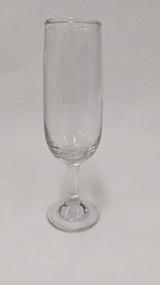 Glass champagne flute with white Kingston Arts logo printed on it