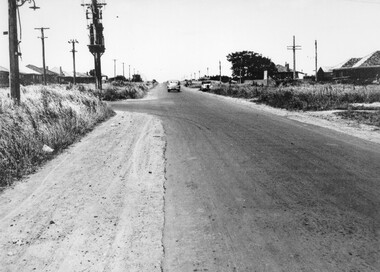 Car travelling along South Road, Moorabbin, looking east, with Tucker Road to the left.
