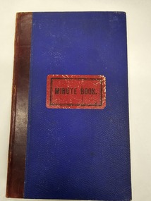 Front cover of minute book, heavy blue card with red leather spine.