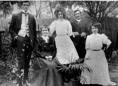 The Fairlam family posing for a photograph in their backyard.