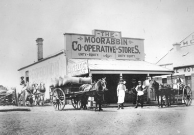 Two men standing in front of Moorabbin Co-operative Store with two horse drawn wagons